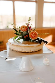 a cake with flowers on top sitting on a table