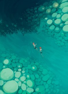 two people are swimming in the ocean with bubbles on the water and pebbles all around them