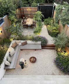 an aerial view of a backyard with seating and trees