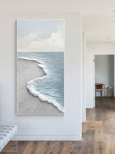 a white room with a painting on the wall