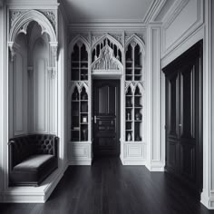 a black and white photo of a living room with an ornate bookcase in the corner