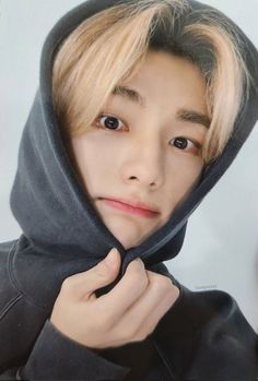 a young man with blonde hair wearing a hoodie