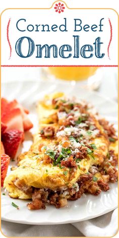 an omelet on a white plate with strawberries and orange juice in the background