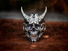 sterling silver inferno demon skull ring, birthday gift, Christmas gift, storyteller. About 33 grams in weight, 4.1 cm from the chin to the tips of horns, 3.4 cm from the chin to the top of head. All ring sizes are possible to order. Please don't hesitate to send me a message if your ring size is not in the regular size chart! "From the Abyss" series, FTA-R008; Ninety Thousand Killer-Ogres Alpha type.  They are led by Thunder Blast~~The Lord of the second Abyss Asura. With their outstanding mili Halloween Engraved Skull Ring Gift, Handmade Silver Skull Ring For Halloween, Handmade Skull Ring As Gift, Handmade Skull Ring Gift, Handmade Skull Ring For Gift, Demon Skull, Lost Wax Casting, Tree Pattern, Birthday Gift For Him