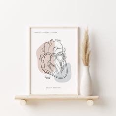 a white vase sitting on top of a wooden shelf next to a framed heart poster