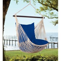 a blue hammock chair hanging from a tree