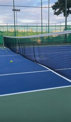 two tennis players are on the court with their racquets and ball in the air