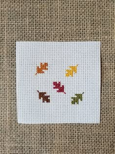 a cross stitch pattern with autumn leaves on it