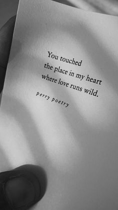 a person holding up a piece of paper with a quote on it that reads, you touched the place in my heart where love runs wild