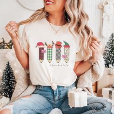 A Christmas teacher shirt featuring a variety of Christmas pencils portraying Santa, reindeer and an elf. Share your love for fall with your students or give this cute teacher tee as a unique teacher gift! Christmas Teacher Shirt, Christmas Pencil Shirt Teacher Life Trendy Tshirt Cute Holiday Shirt Teacher Gift Holiday Shirt for Classroom Xmas **SIMPLE STEPS TO ORDER** 1) Please review ALL product photos including Size Chart. 2) Select your T-Shirt color and T-Shirt size from the drop-down optio Xmas Teacher Shirt, Unique Teachers Gift, Teacher Design, Santa Reindeer, Teacher Tees, Holiday Shirt, Teacher Christmas, Holiday Shirts, Trendy Tshirts