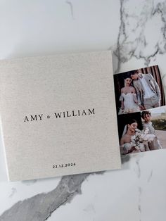 the wedding album is laying on top of the marble countertop next to it's matching photos