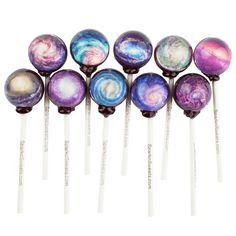 six lollipops with galaxy designs on them are lined up in a row