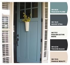 a blue front door with white shutters and a flower pot on the side window