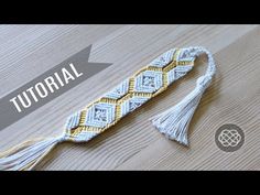 a white and yellow crochet tassel on a wooden table