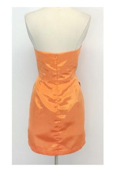 Size 8 Strapless Pleat Dress in Orange Sherbet Retails for $305.00 Body 100% Polyester Lining 100% Acetate Made in the USA Concealed back zip and clasp Pleat detail on bust and below waist On seam hip pockets Bone in bodice Across top of bust 16.5" Under bust 15.25" Bust to hem 19.25" Hips 38.5" Total length 28" Fitted Knee-length Strapless Dress With Lining, Orange Fitted Dress With Straight Neckline, Fitted Silk Strapless Dress, Silk Fitted Strapless Dress With Straight Neckline, Orange Fitted Lined Mini Dress, Fitted Silk Strapless Dress For Cocktail, Spring Strapless Dress With Sweetheart Neckline, Chic Orange Formal Dress, Orange Mini Length Dress For Formal Occasions