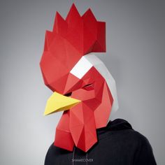 a person wearing a paper mask with a chicken on it's head and the face of a rooster