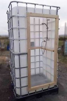 a large white container sitting on top of a dirt field