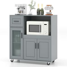 a microwave oven sitting on top of a gray cabinet next to a white countertop