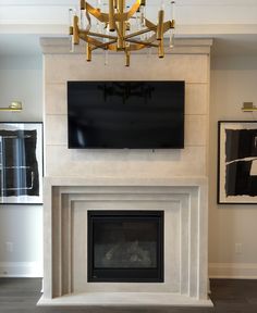 a living room with a fireplace and tv mounted on the wall above it's mantle