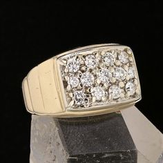 a diamond ring sitting on top of a rock