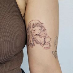 a woman with a tattoo on her arm holding a teddy bear and hugging it's face