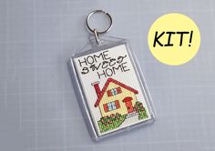 a house keychain with the words home sweet home written on it