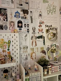 a room filled with lots of dolls and pictures on the wall