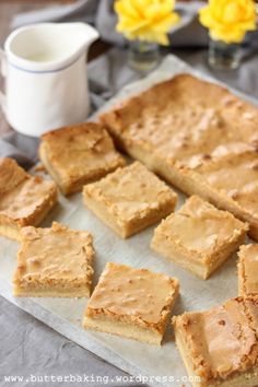 peanut butter bars on a tray with flowers in the background