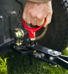 a man is holding a wrench while working on a vehicle