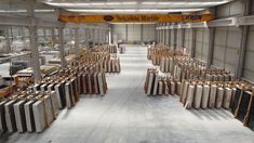 an industrial warehouse filled with lots of different types of tile and wooden pieces on display