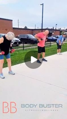 a group of people standing on top of a sidewalk