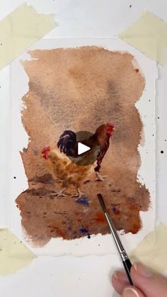 a person is painting a chicken with watercolors