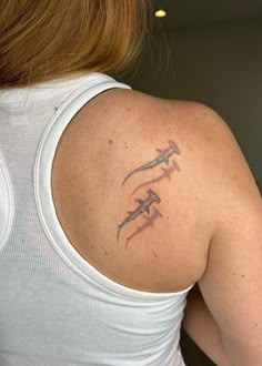 a woman with a tattoo on her back shoulder