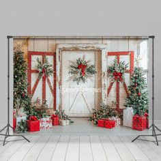 a christmas scene with presents and wreaths in front of a barn door wall mural