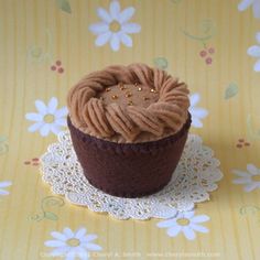 a cupcake on a doily with gold sprinkles