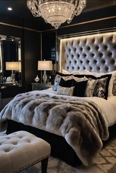 a luxurious bedroom with black walls and white fur on the bed, chandelier