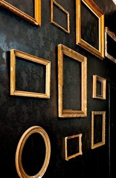 there are many gold frames on the wall