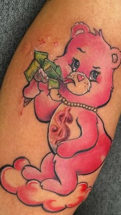 a pink teddy bear tattoo on the leg