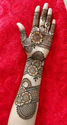 henna tattoo designs for hands and feet on the red carpet with white flowers in the middle