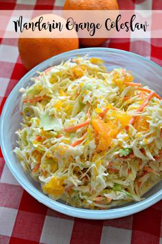 a bowl filled with coleslaw sitting on top of a checkered table cloth