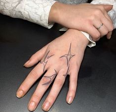 two hands that have tattoos on them and one has a ring finger with an antelope tattoo