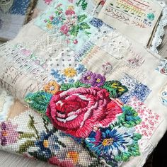 an old patchwork purse with flowers on the front and side, sitting on a table