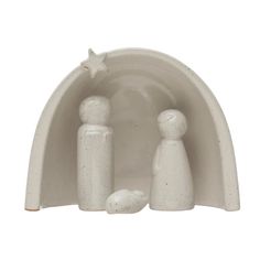 a white ceramic figurine with three people under a star on the top and bottom