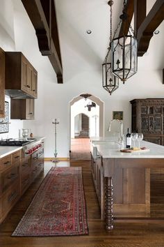 a large kitchen with wooden cabinets and an area rug