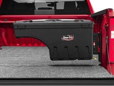 the back end of a red truck with its cargo compartment open