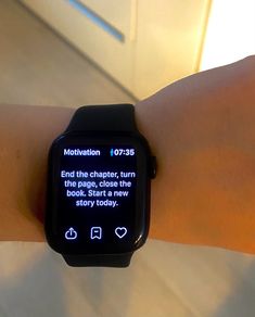 a person wearing a smart watch on their wrist with the message'motivation'displayed