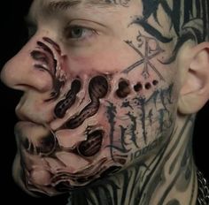 a man with tattoos on his face and neck