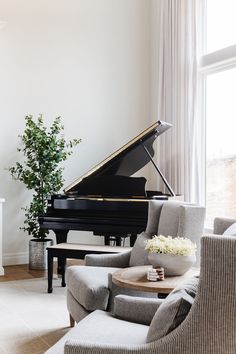 a living room filled with furniture and a grand piano