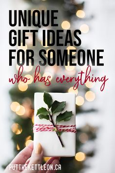 someone holding up a present with the words unique gift ideas for someone who has everything