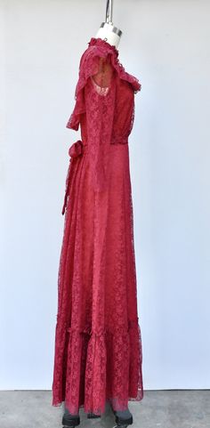 "Vintage Lace Maxi Dress in Vibrant Cranberry Color! Perfect for a vintage wedding !! This is STUNNING !! *Ruffled *Floral Lace *Lace is see through on neck and sleeves *Long Sleeves - Please note that the right sleeve was cut short - do not know why as the other one is original length. This is how we found it and sold As Is. Pretty simple job for a seamstress to shorten the other one to make them the same length. Priced accordingly! *Zip up on back *Floor Length *Lined - Lace even on back part Floor-length Lace Dress For Vintage Events, Vintage Floor-length Maxi Dress For Formal Occasions, Vintage Lace Dress With Long Sleeves, Vintage Long Evening Dress, Vintage Floor-length Maxi Dress With Ruffles, Vintage Floor-length Ruffled Maxi Dress, Vintage Lace Floor-length Dress, Vintage Floor-length Lace Dress, Vintage Lace Trim Maxi Dress For Evening